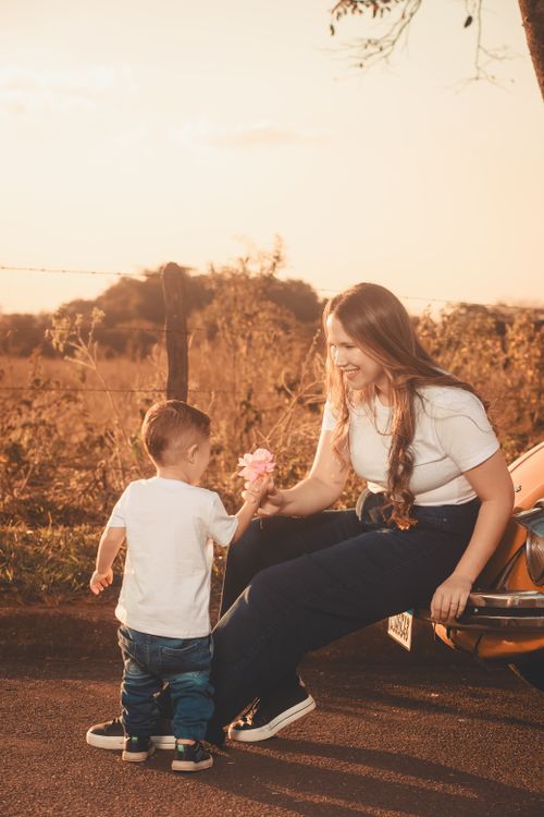 Free A mother and child share a tender moment during a fall sunset outdoors. Stock Photo