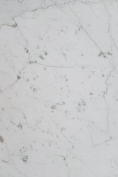 Elegant white marble with subtle gray veins, perfect for backgrounds or product displays.