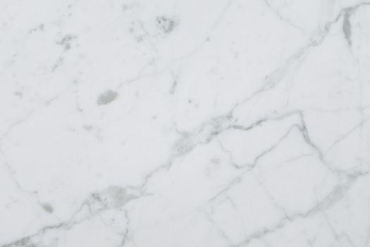 High-quality white marble surface with natural patterns for background or texture use.