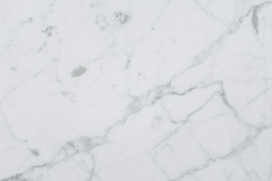 High-quality white marble surface with natural patterns for background or texture use.