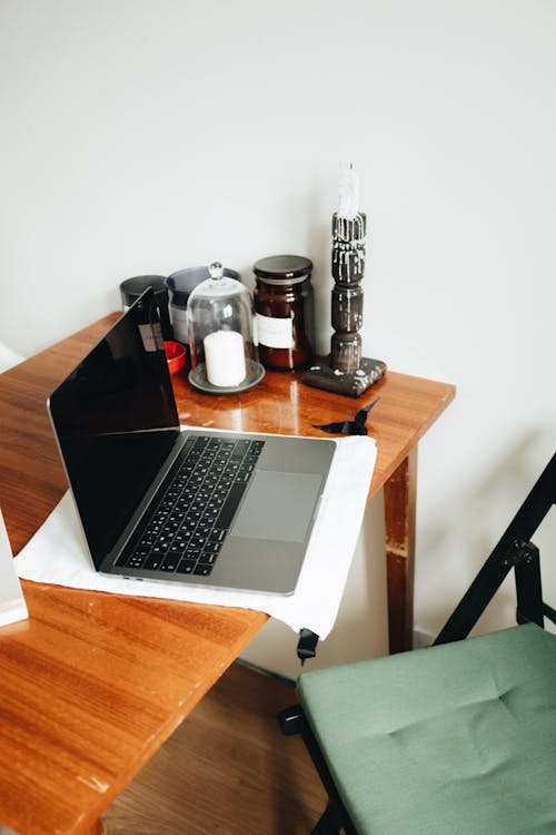 Macbook Pro On Brown Wooden Table