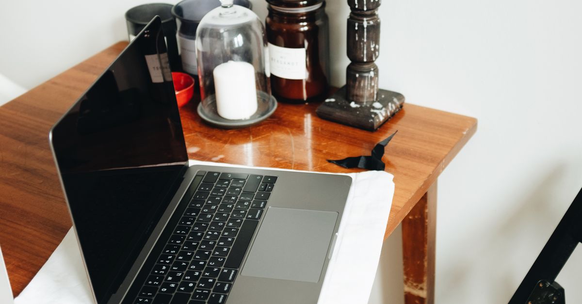Macbook Pro On Brown Wooden Table · Free Stock Photo