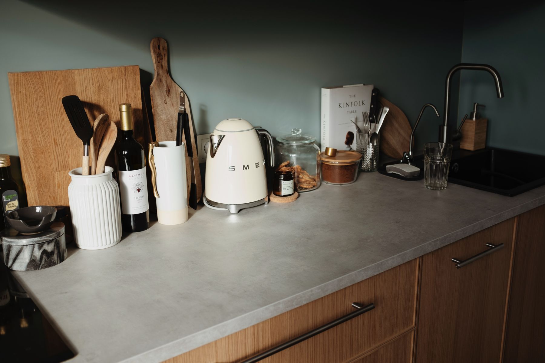 Warm modern kitchen scene with cookware, preparation tools and countertop essentials