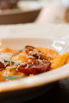 Delicious Italian pasta garnished with cherry tomatoes and grated parmesan cheese.