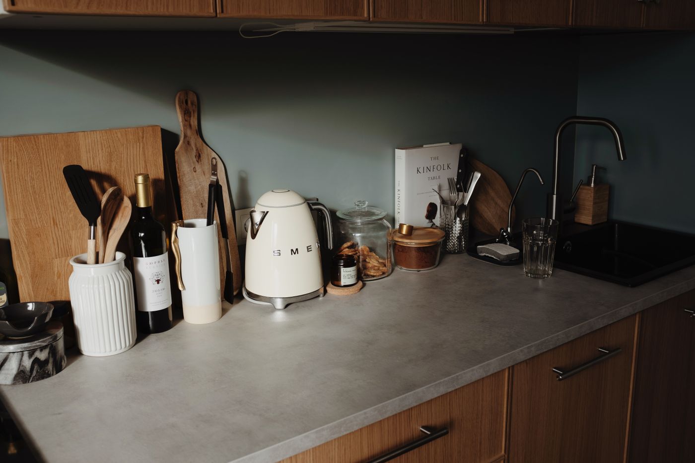 Minimalist kitchen countertop with household cooking equipment and utensils in soft natural light