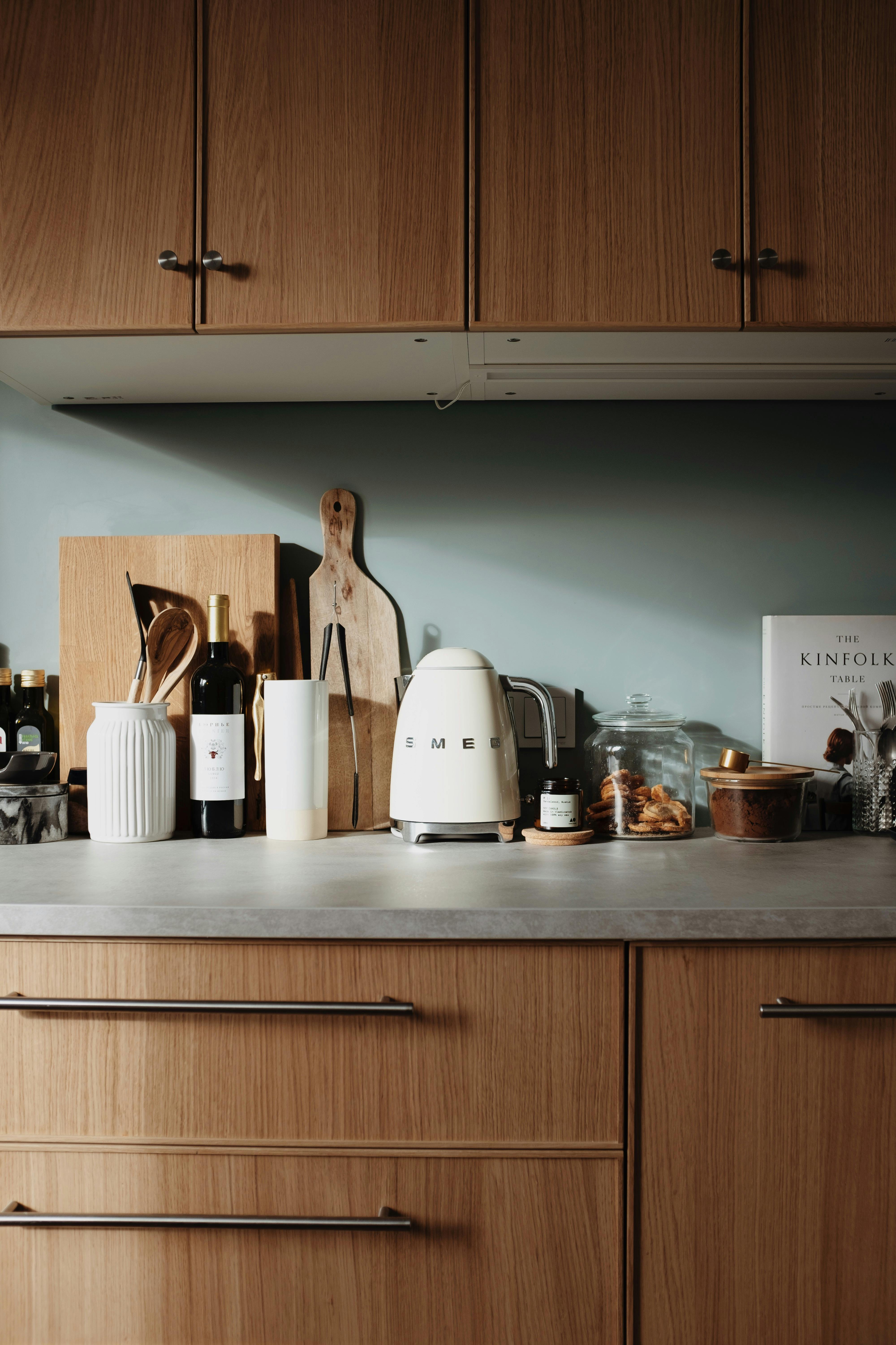 Modern electric kettle and cups of tea on white wooden table in kitchen.  Space for text Stock Photo by ©NewAfrica 317399329