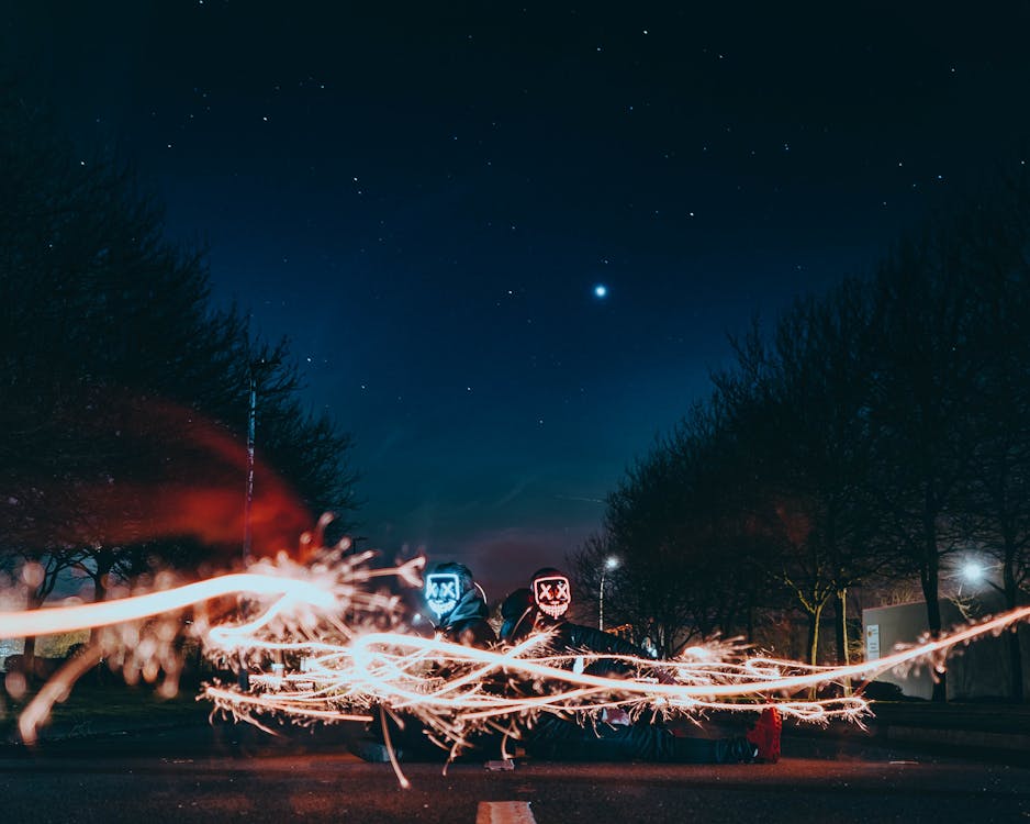 People Sitting on Road during Night Time