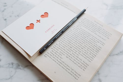 Free Black Pen on Open Book Stock Photo