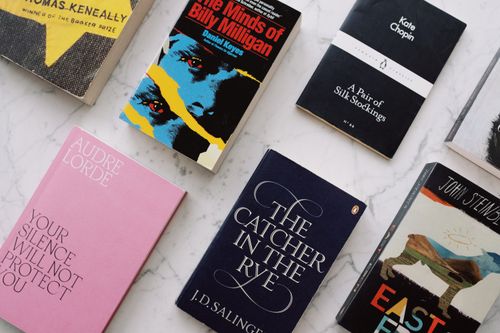 Free From above view of set of various classic novels with colorful images on covers placed on white marble surface Stock Photo