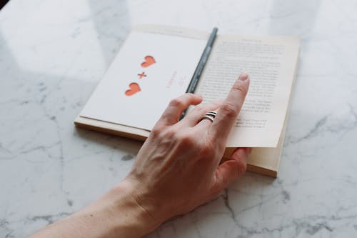 Free Person Turning Book Page Stock Photo