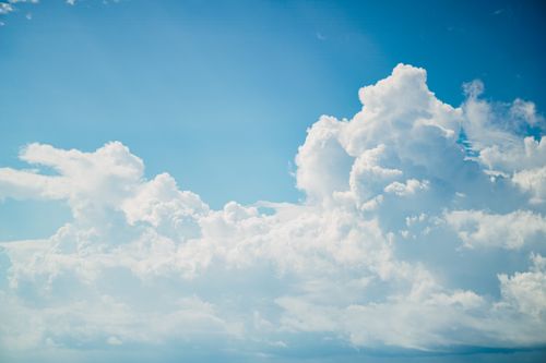 Free A captivating view of bright, cumulus clouds against a vivid blue sky. Stock Photo