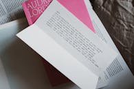 Paper with text lying over book