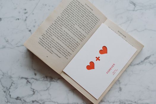 Opened book with valentine lying inside