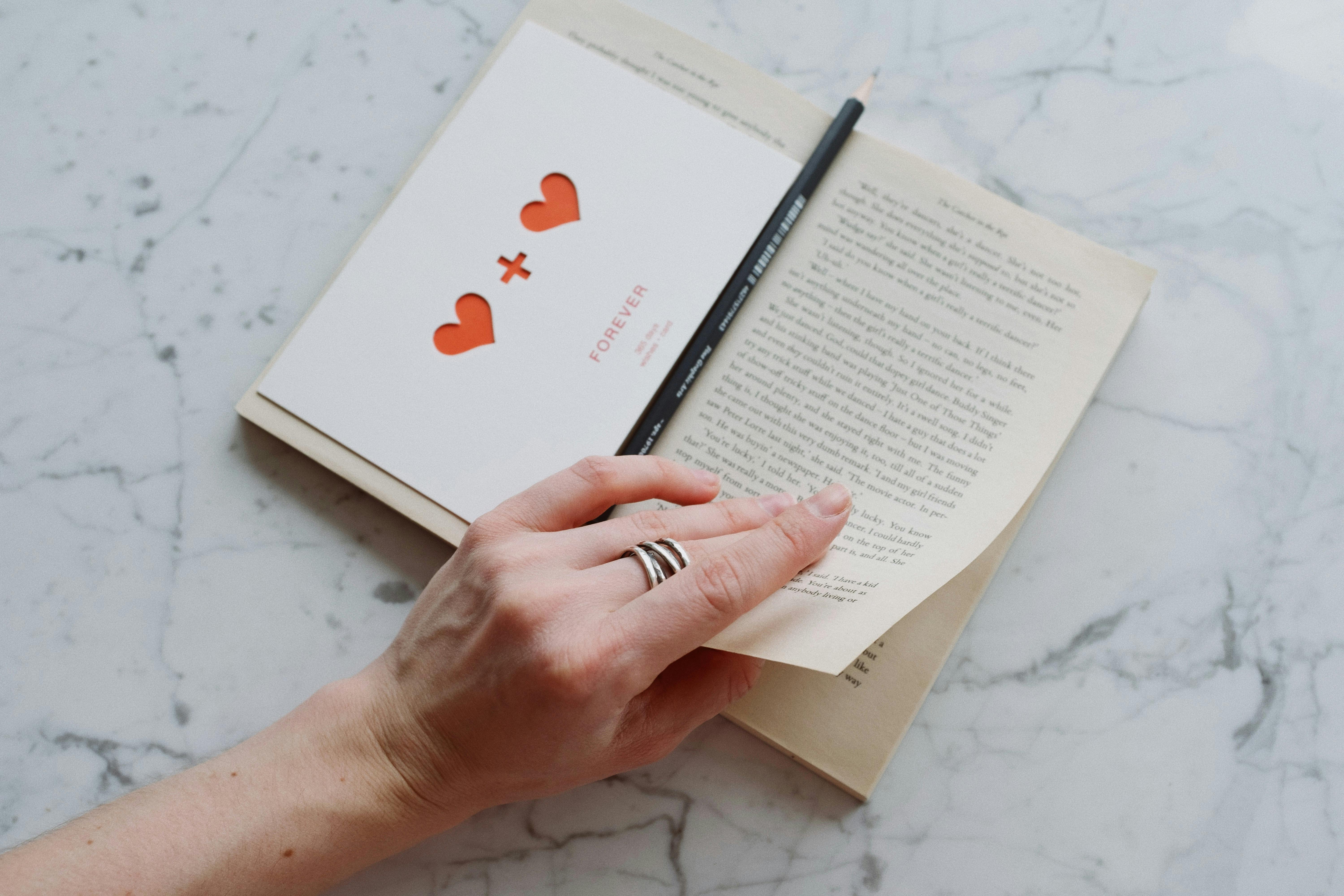 faceless woman reading interesting story in book