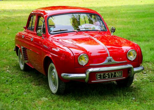Free Classic red Renault parked outdoors, showcasing vintage automotive design and elegance. Stock Photo