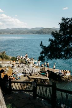 Tourists enjoy leisure time on the picturesque coastline of Akyaka, Türkiye.