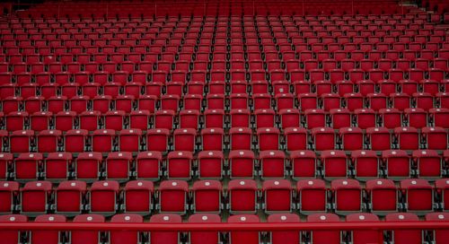 Free Rows of empty red seats in a Berlin stadium, creating a symmetrical pattern. Stock Photo
