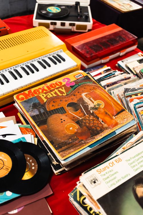 Free Colorful display of vintage vinyl records and a retro keyboard on a market stall. Stock Photo