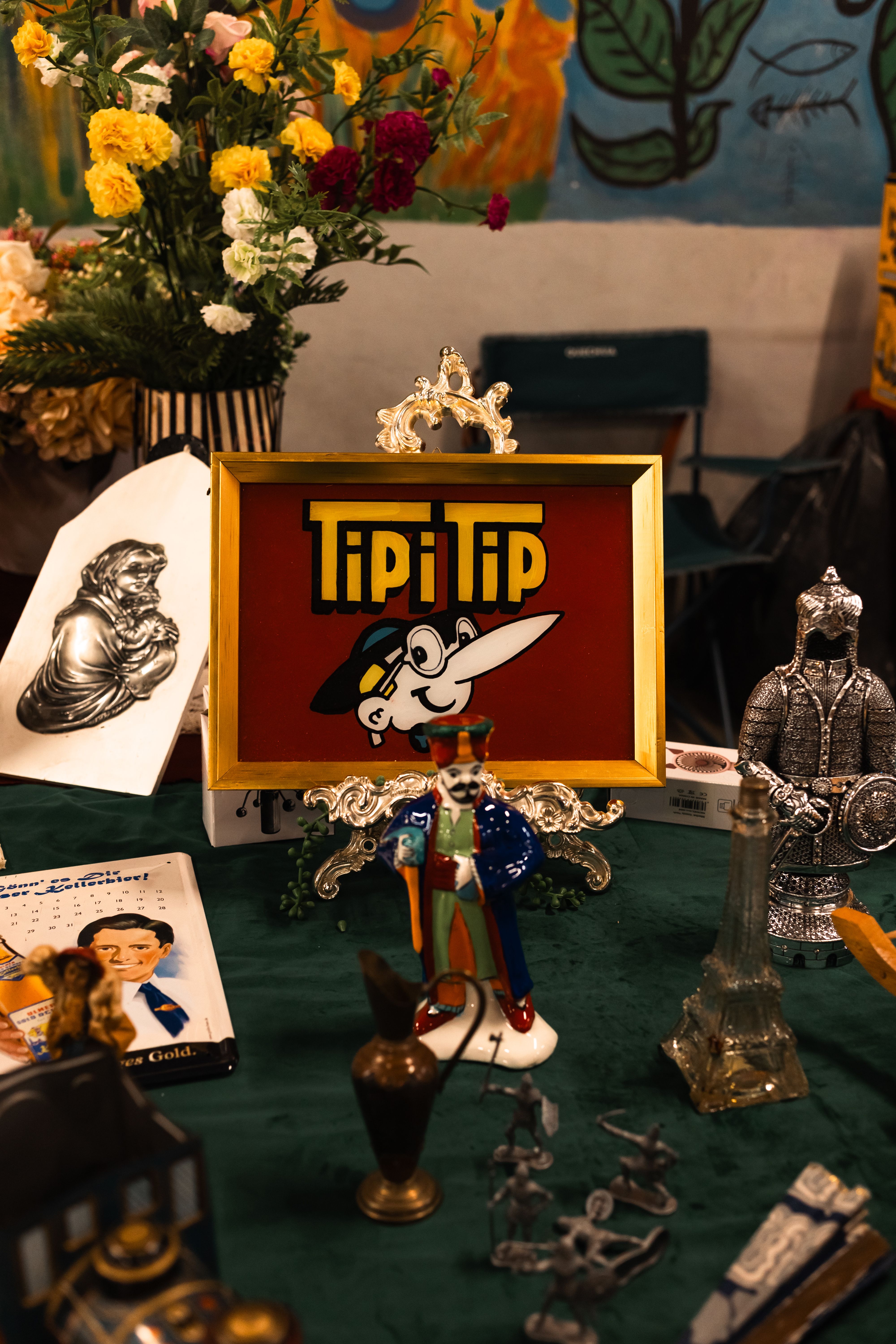 Colorful vintage display featuring collectibles and a Tipi Tip cartoon character sign.