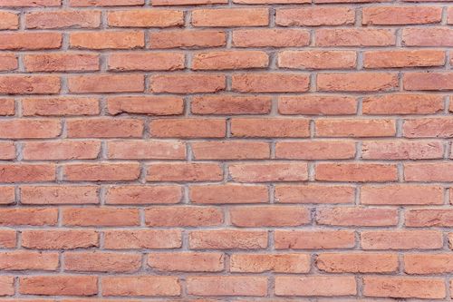 Free Detailed red brick wall background perfect for texture and design. Stock Photo
