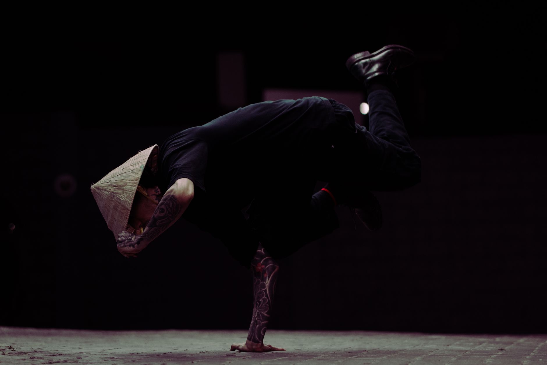 A winger performing a sharp body feint beside a defender during an intense evening football practice