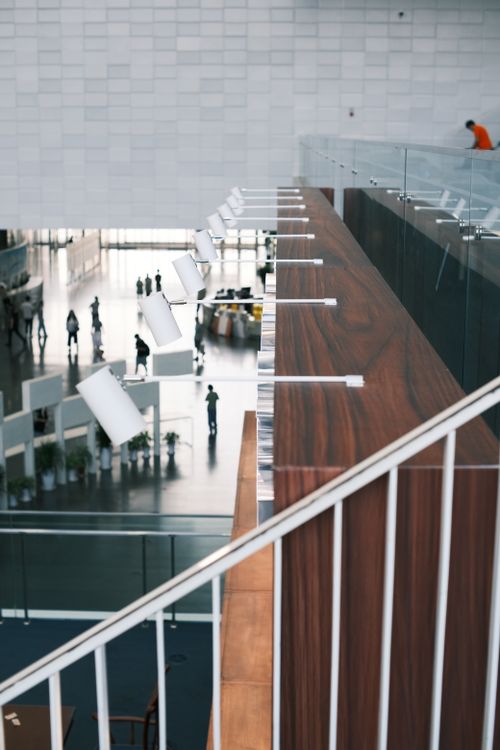 Free A stylish, contemporary indoor public area with minimalist architecture and wood accents. Stock Photo