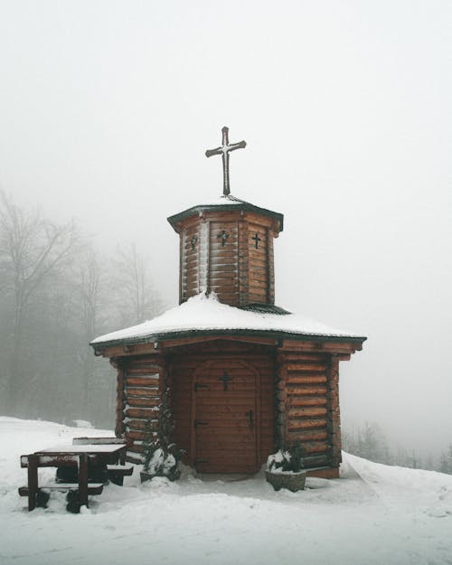 Brown Wooden Church Covered In Snow