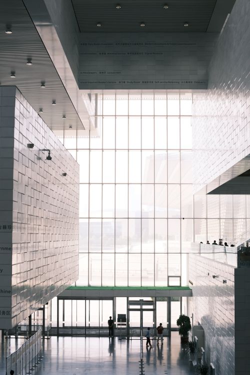 Free Spacious modern interior with high ceilings, large windows, and minimalistic design. Stock Photo