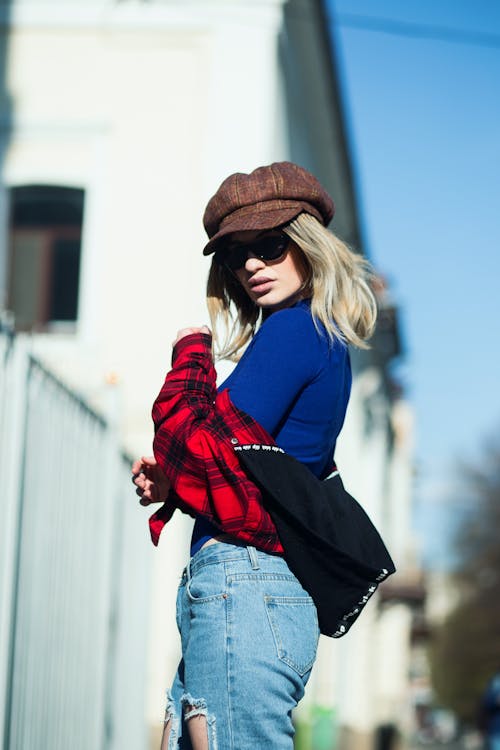 Woman In Blue Long Sleeve Shirt And Blue Denim Jeans
