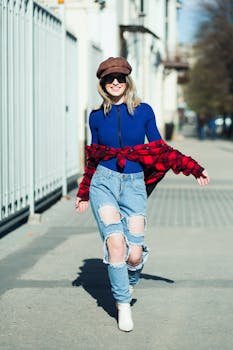 Stylish woman in casual outfit strolling outdoors on a sunny day.