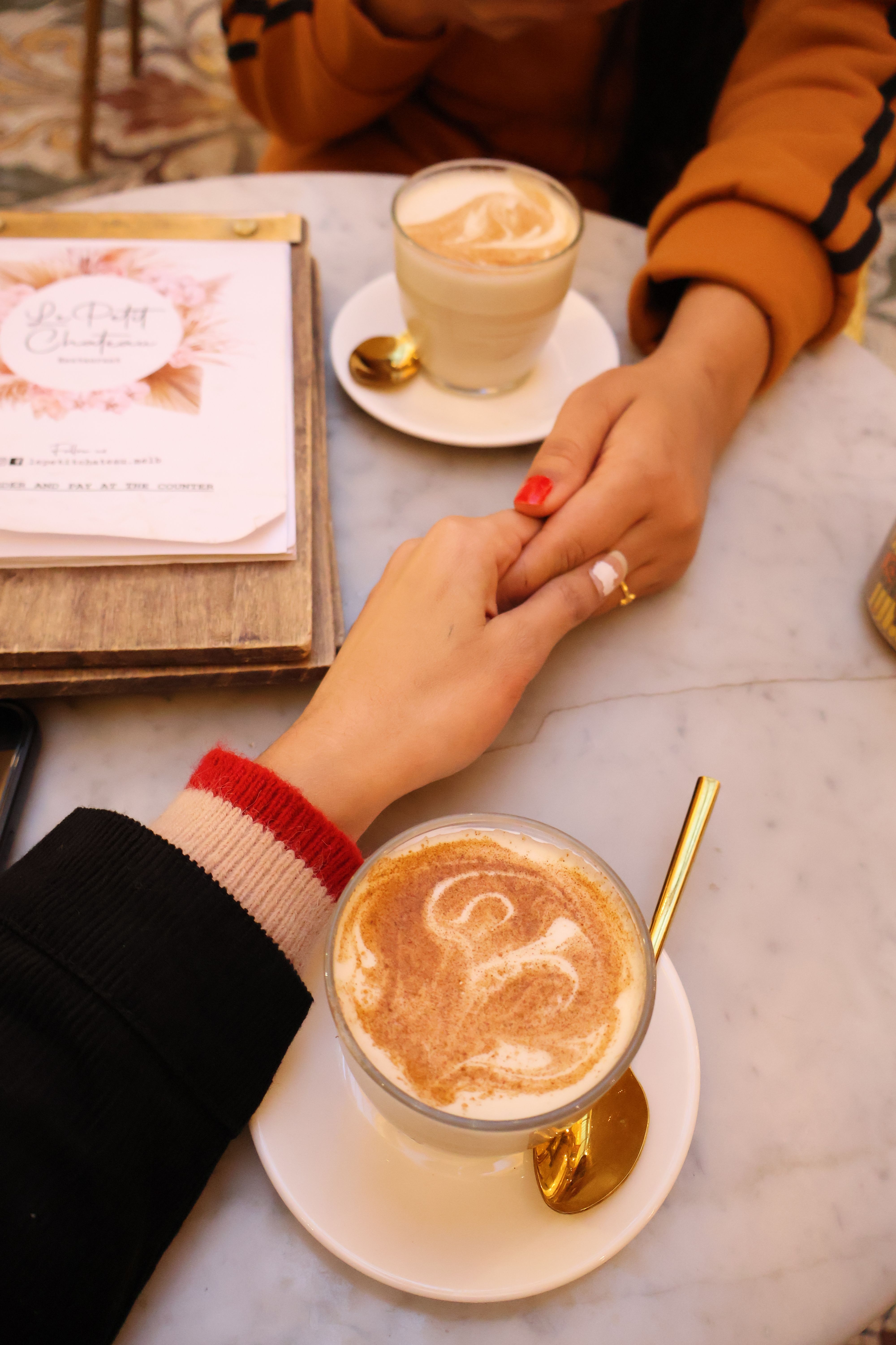 A heartfelt moment shared over lattes in a cozy cafe setting, showcasing genuine connection.