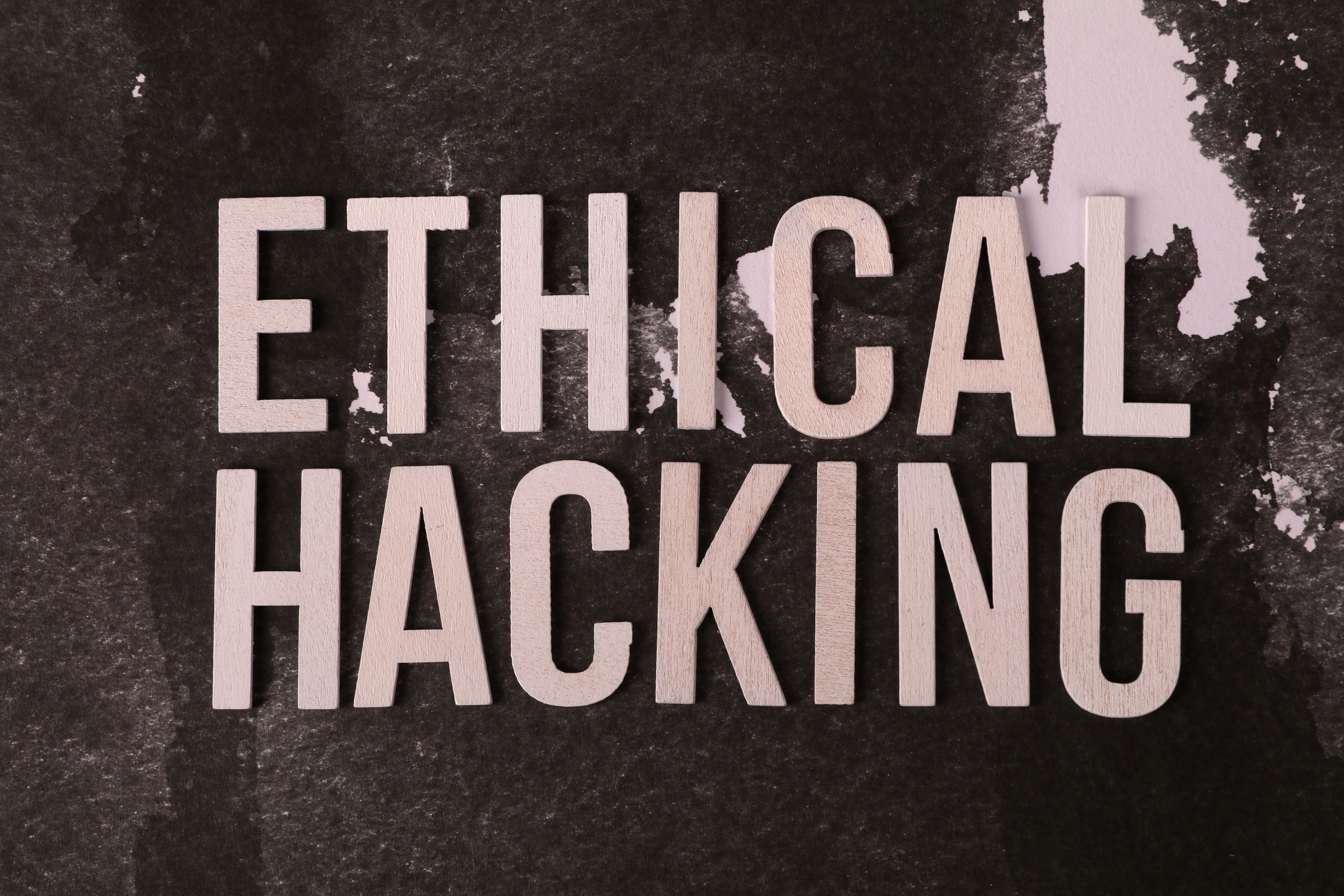 Creative composition with 'Ethical Hacking' text on textured background for cybersecurity theme.