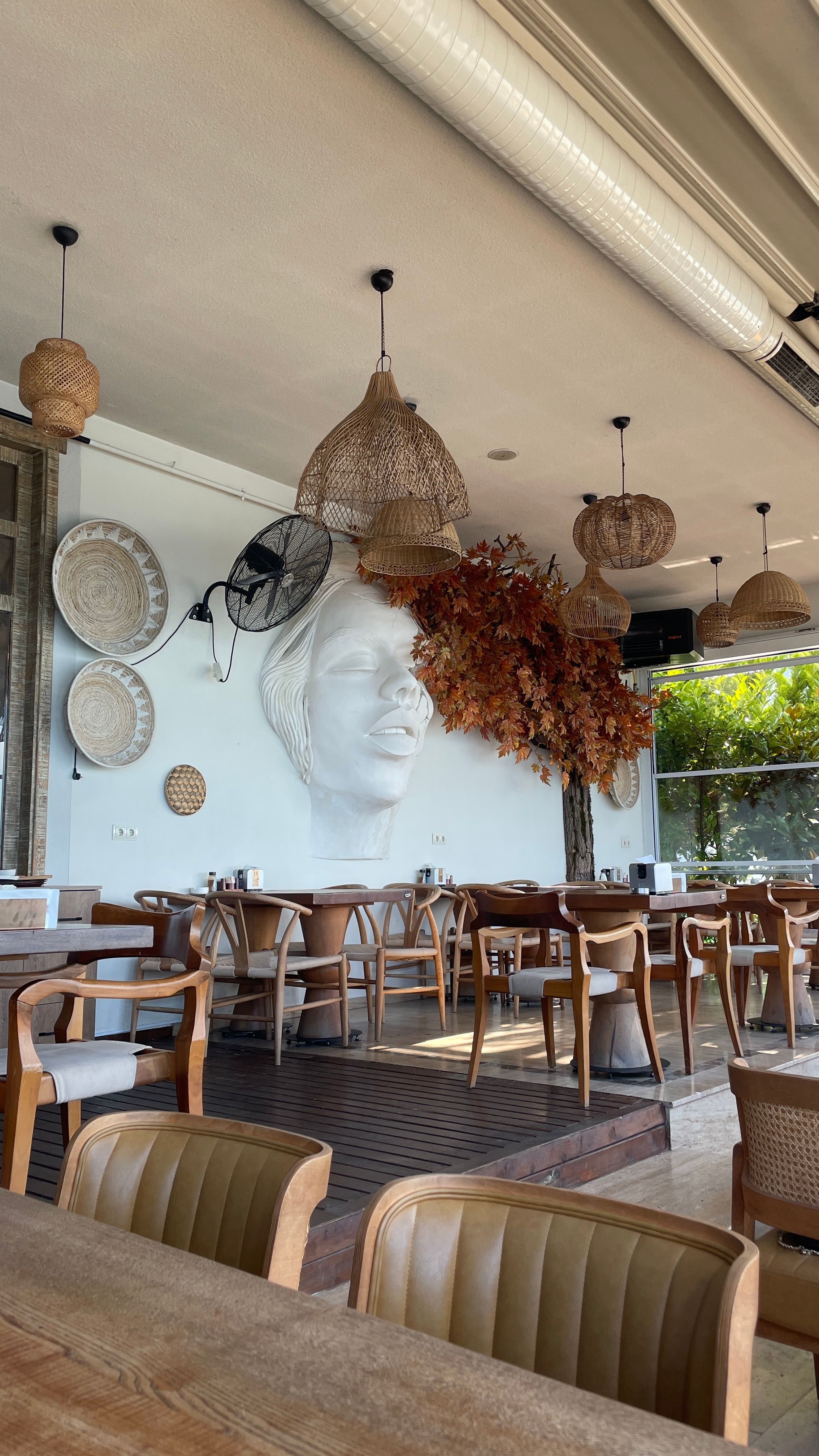 Stylish cafe interior with woven decor and modern furnishings in Trabzon, Türkiye.