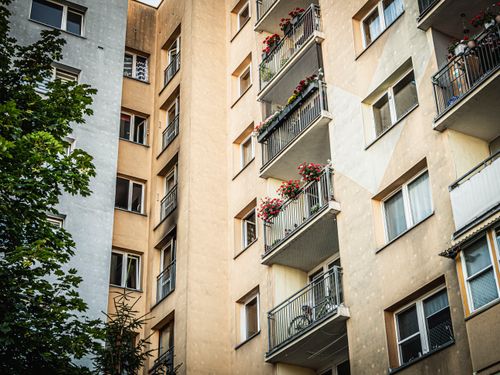 Free Exterior view of a residential building in Wrocław featuring balconies adorned with flowers. Stock Photo