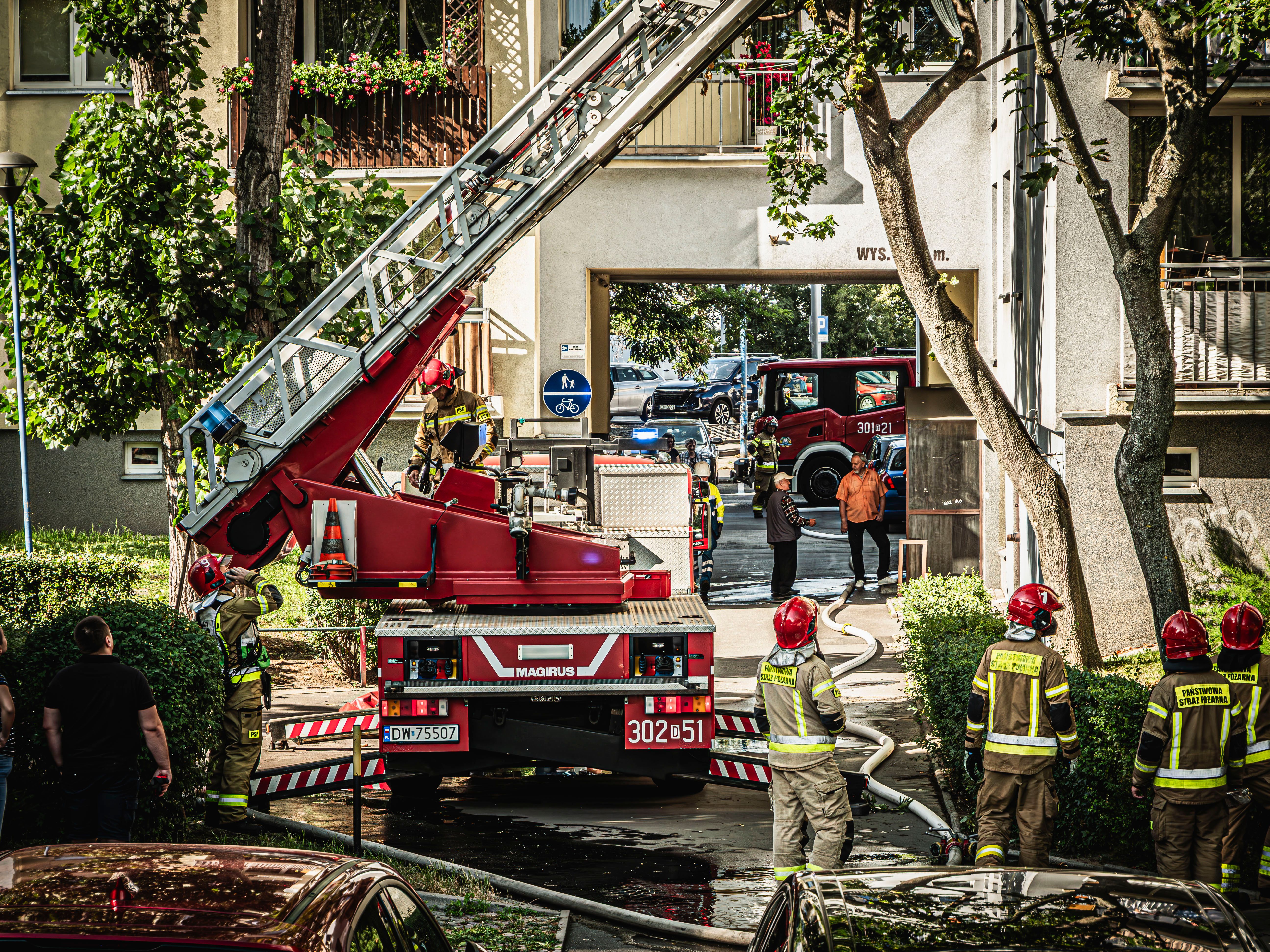 Fire trucks and firefighters in action during a firefighting operation in Wrocław, Poland.