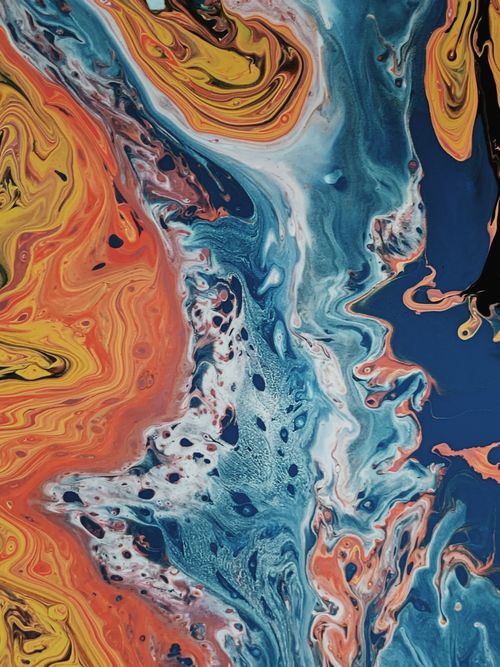 Free From above of oil painting representing water flows with small ink stains near bright wavy orange lines Stock Photo
