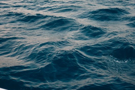 Deep blue ocean waves create a serene and calming scene, perfect for relaxation themes.