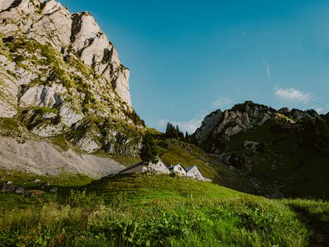 Breathtaking view of Alpine mountains and rustic cottages in Sennwald, Sankt Gallen, Switzerland.