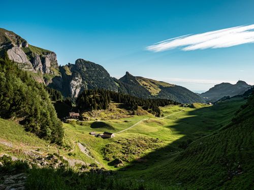 Free Breathtaking view of lush green valleys and rocky mountains in Sennwald, Switzerland. Stock Photo