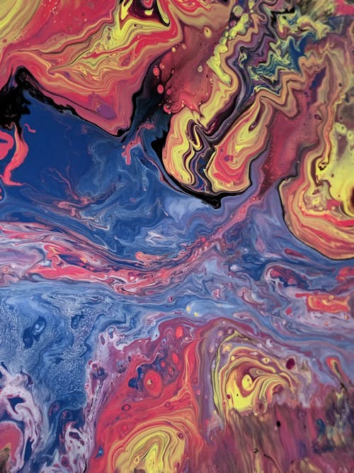 From above of oil picture with blended paints creating contrast between water fluids and multicolored swirls
