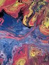From above of oil picture with blended paints creating contrast between water fluids and multicolored swirls