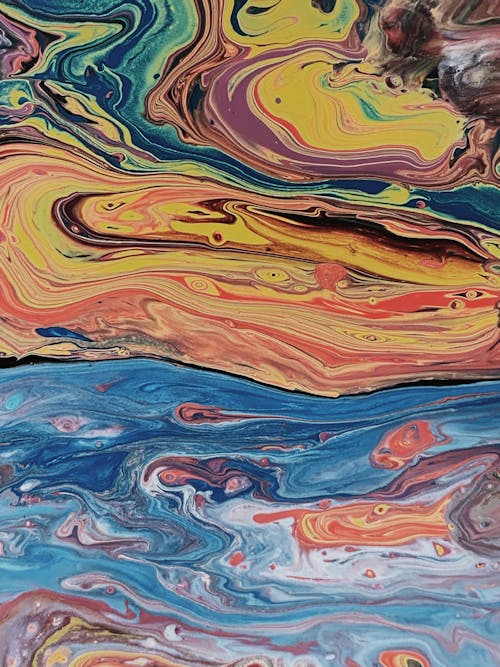 Closeup saturated abstract background covered with multicolored vivid paint randomly lying on surface