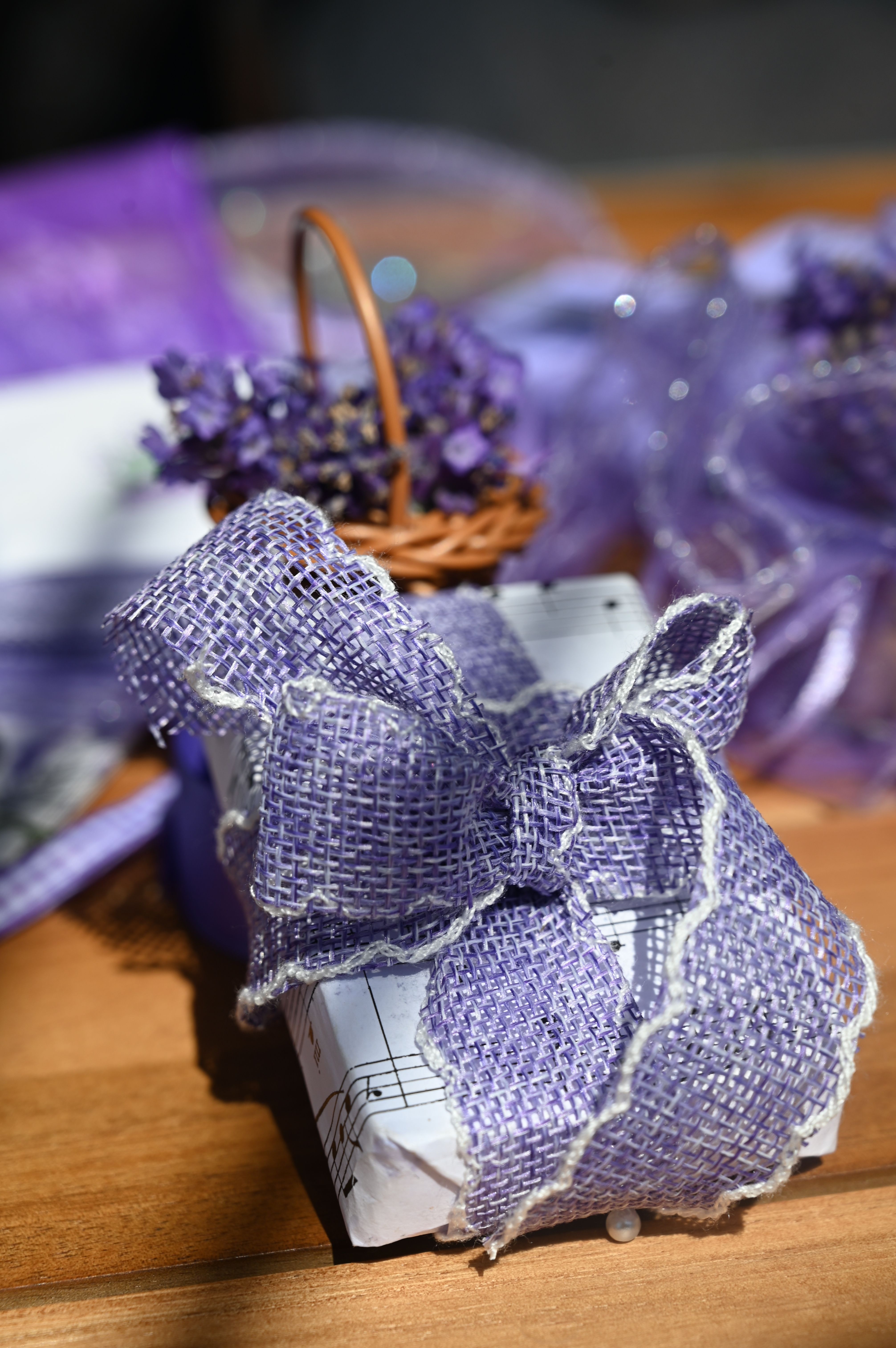 A beautifully wrapped gift with lavender bouquet and purple ribbon, perfect for special occasions.