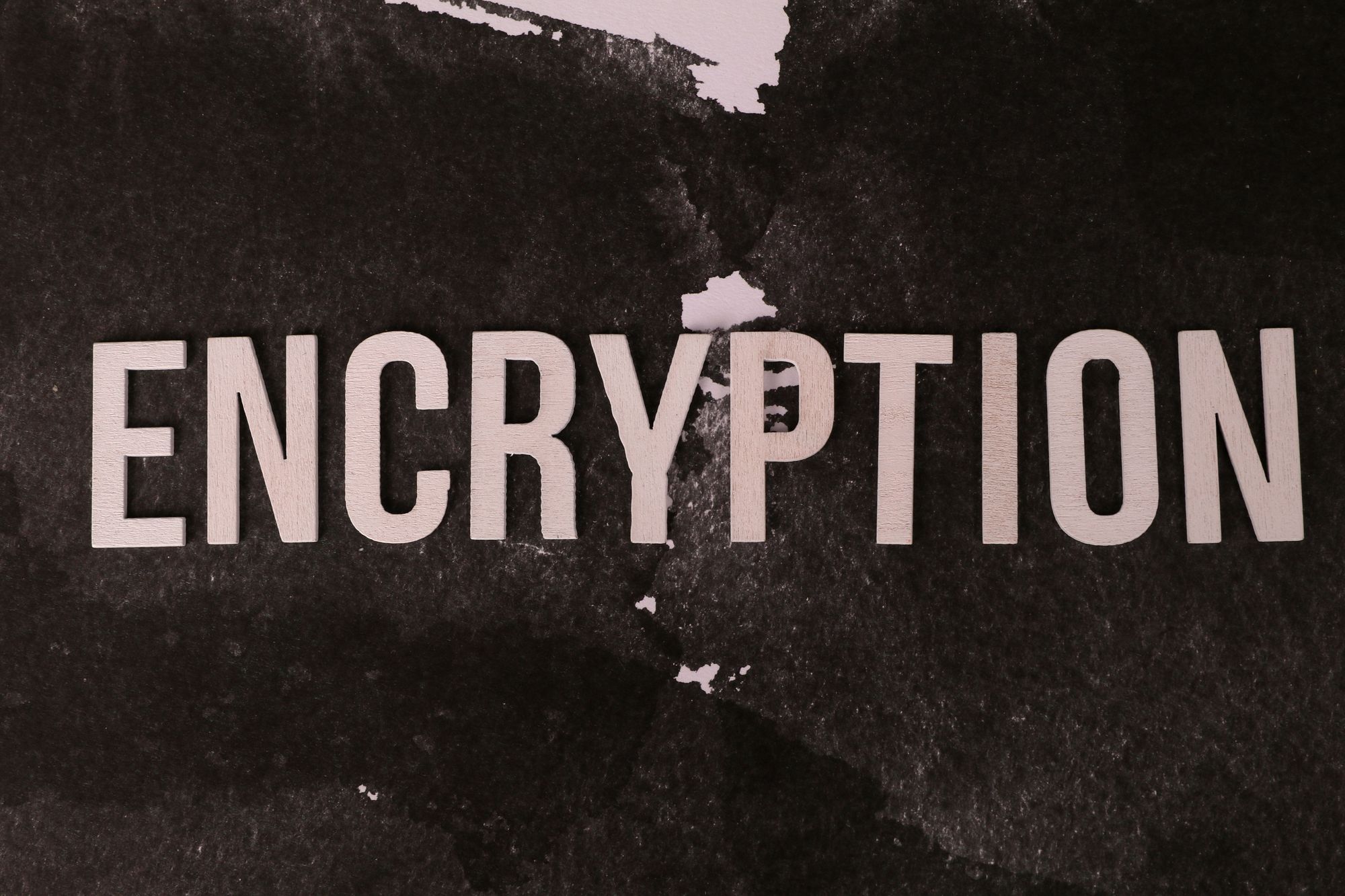Black and white abstract image with the word 'ENCRYPTION' prominently displayed.