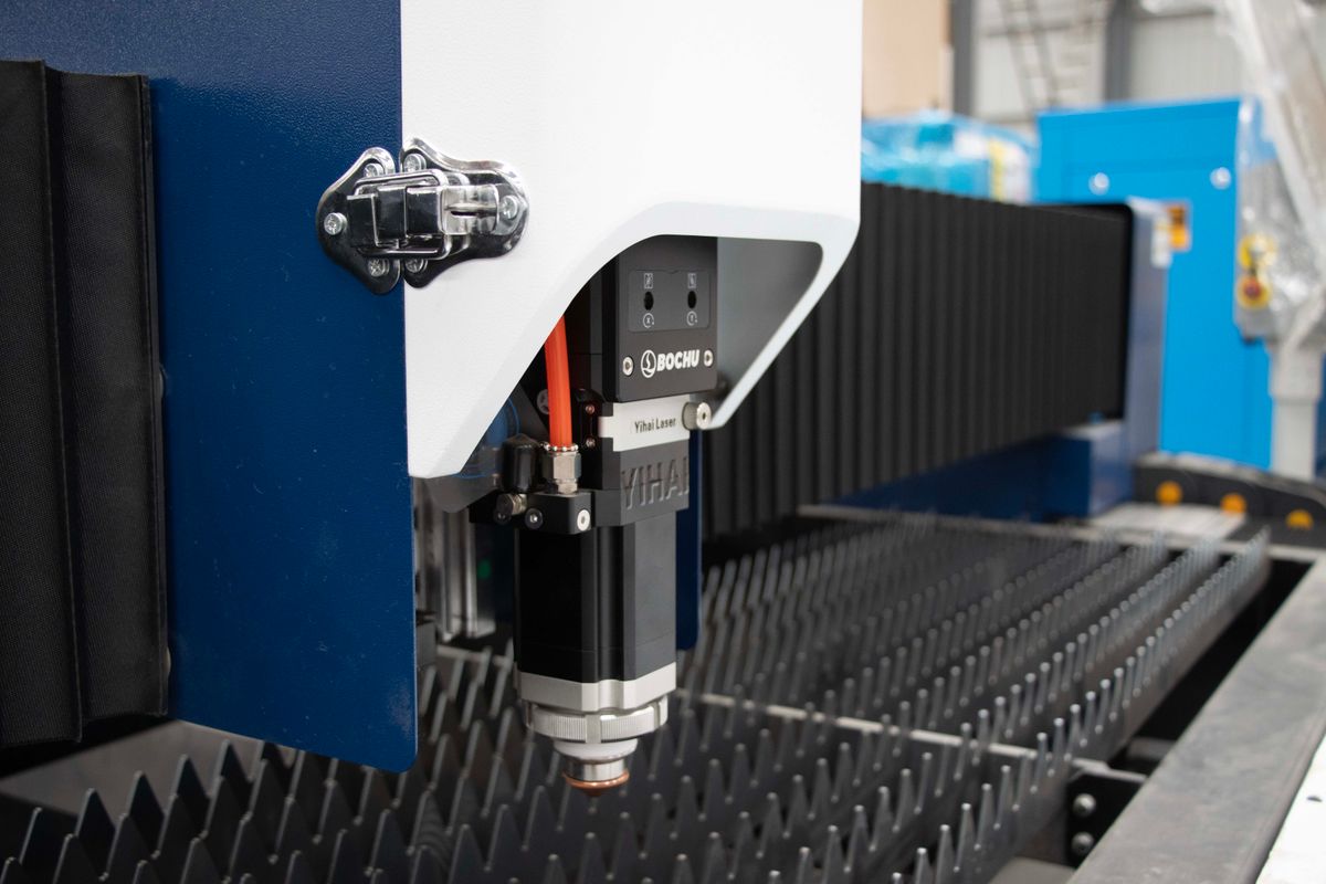 Industrial laser machine operating indoors under blue light