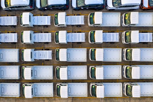 Overhead view of a fleet of trucks neatly parked in a seaport area of Jakarta, Indonesia.