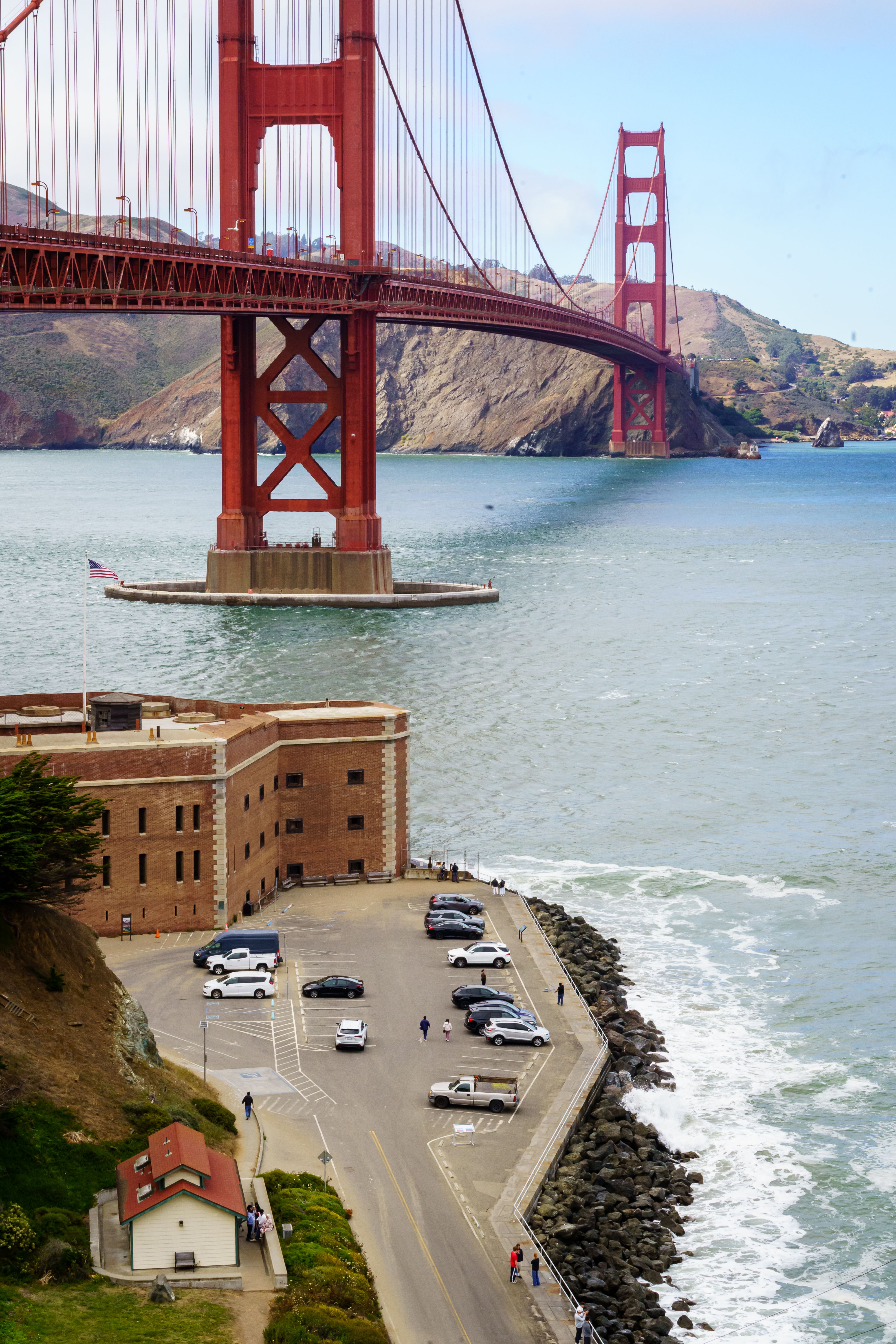 Dramatic view of the Golden Gate Bridge spanning across the bay with Fort Point below.