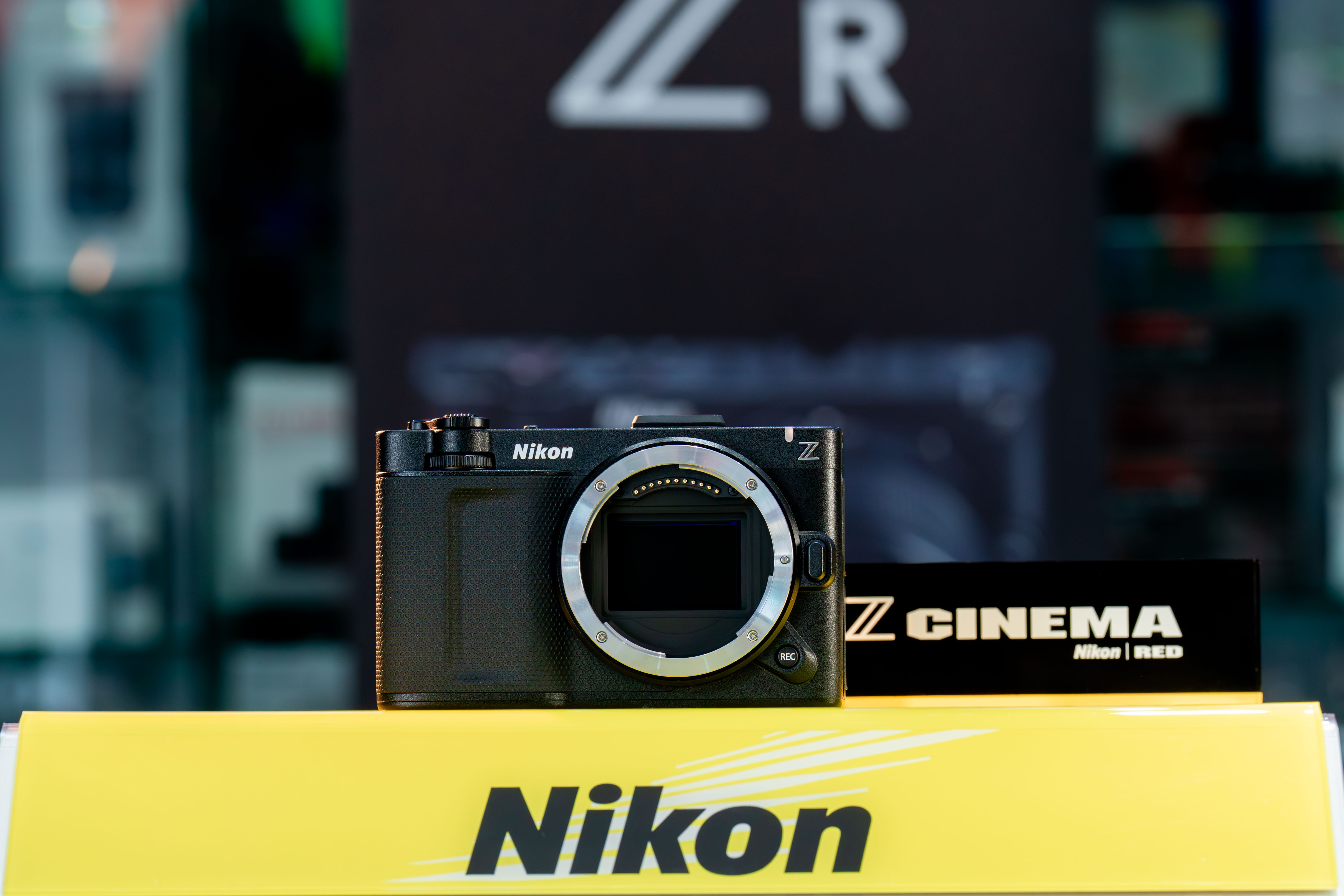 Close-up of a Nikon camera body on a display stand, ideal for photography enthusiasts.