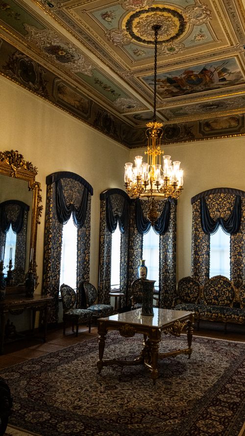 Free A vintage room showcasing ornate decorations, chandeliers, and luxurious furniture. Stock Photo
