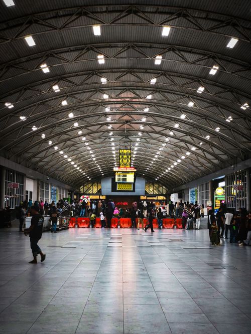 Free Vibrant train station interior bustling with people and illuminated design. Stock Photo